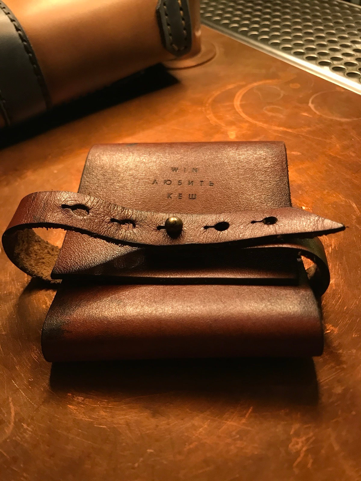WIN check presenter with strap-and-stud closure