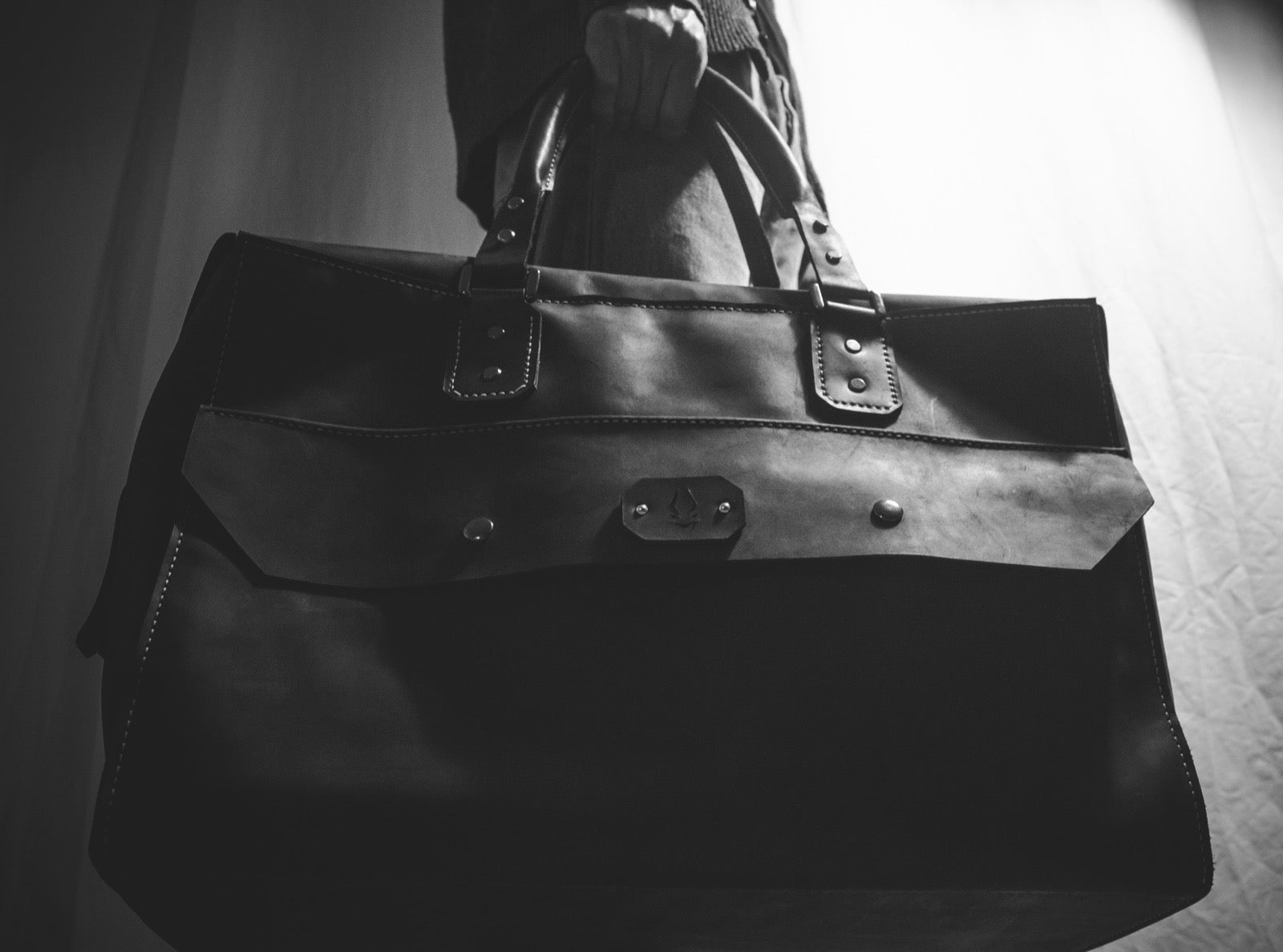 The holdall carried by hand, front view