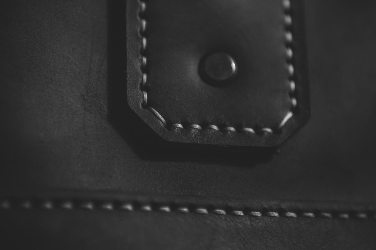 Hand-stitched strap and stud detail